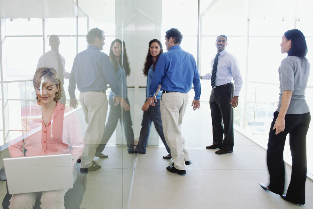 General Mills Brazil - A diverse group of professionals standing together in a office, engaged in conversation.