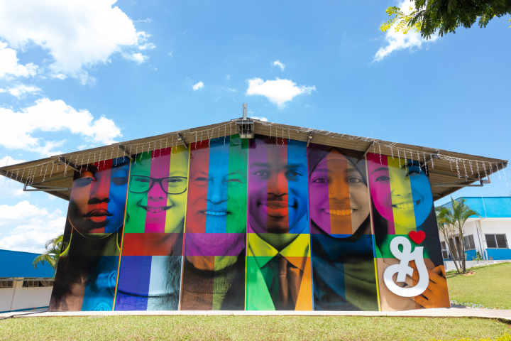 A vibrant mural depicting a diverse group of people in bright colors, celebrating unity, diversity, and community spirit through artistic expression with General Mills Logo